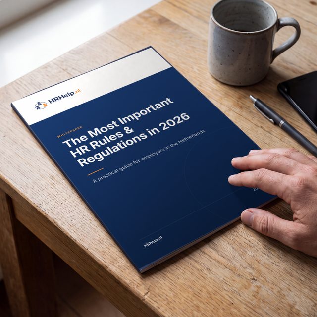 A printed copy of the HR Rules & Regulations 2026 guide on a wooden desk